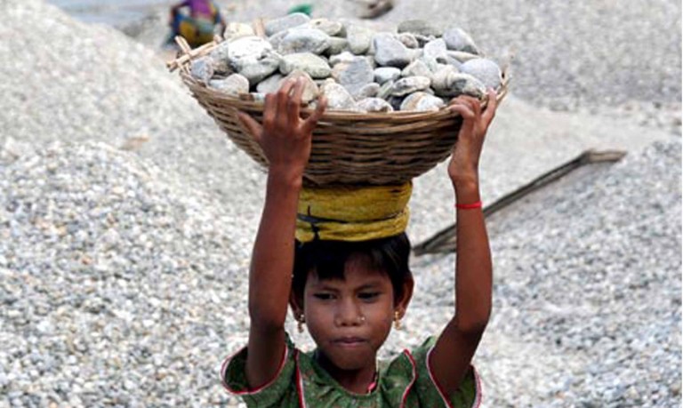 Child labour engaged in road works